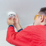 worker-mounting-fire-alarm-ceiling_245047-72